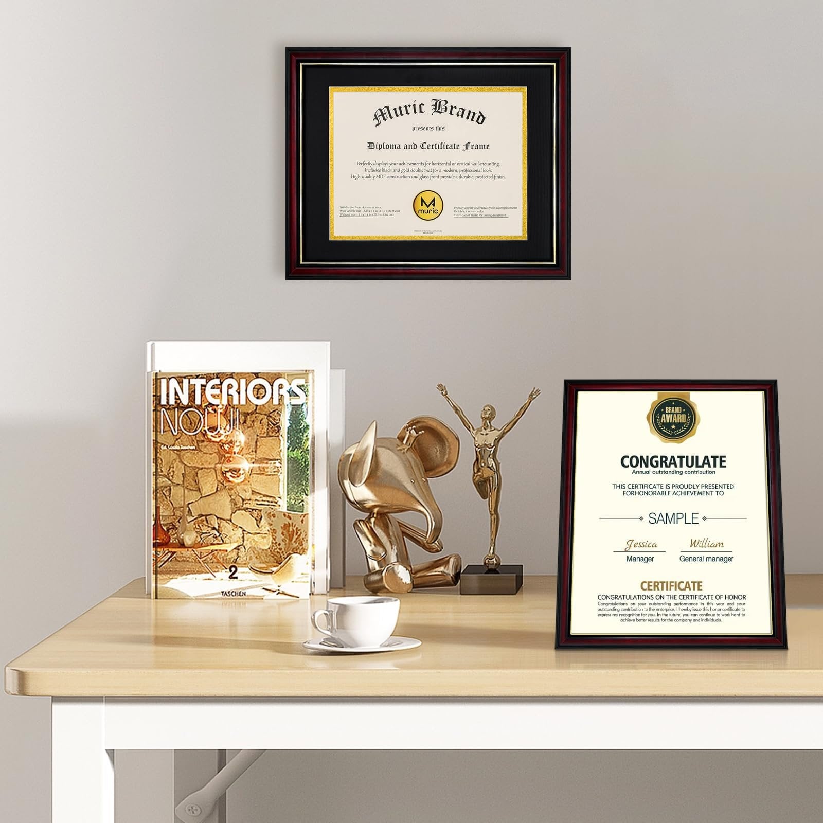 Two diploma frames displayed on a desk with decorative items and a magazine. One frame is on the wall, the other is on the desk.