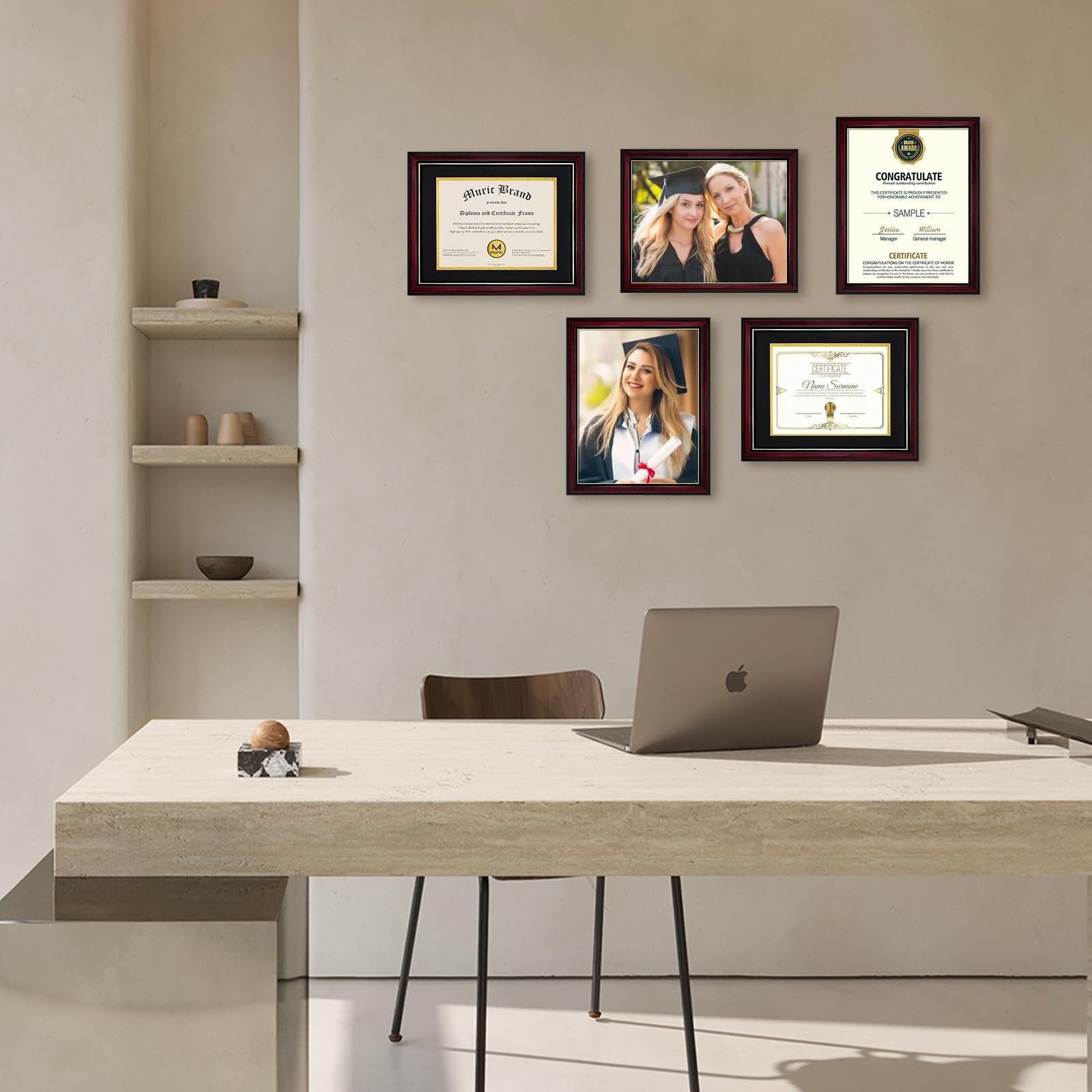 Diploma frames displayed on a wall above a desk with a laptop, featuring graduation photos and certificates.