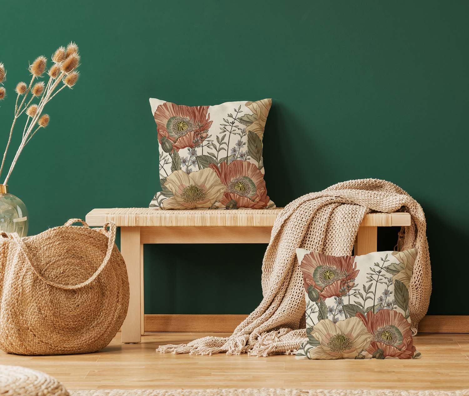 Two vintage floral pillow covers with botanical pattern displayed on a wooden bench with a knit blanket and a woven basket.