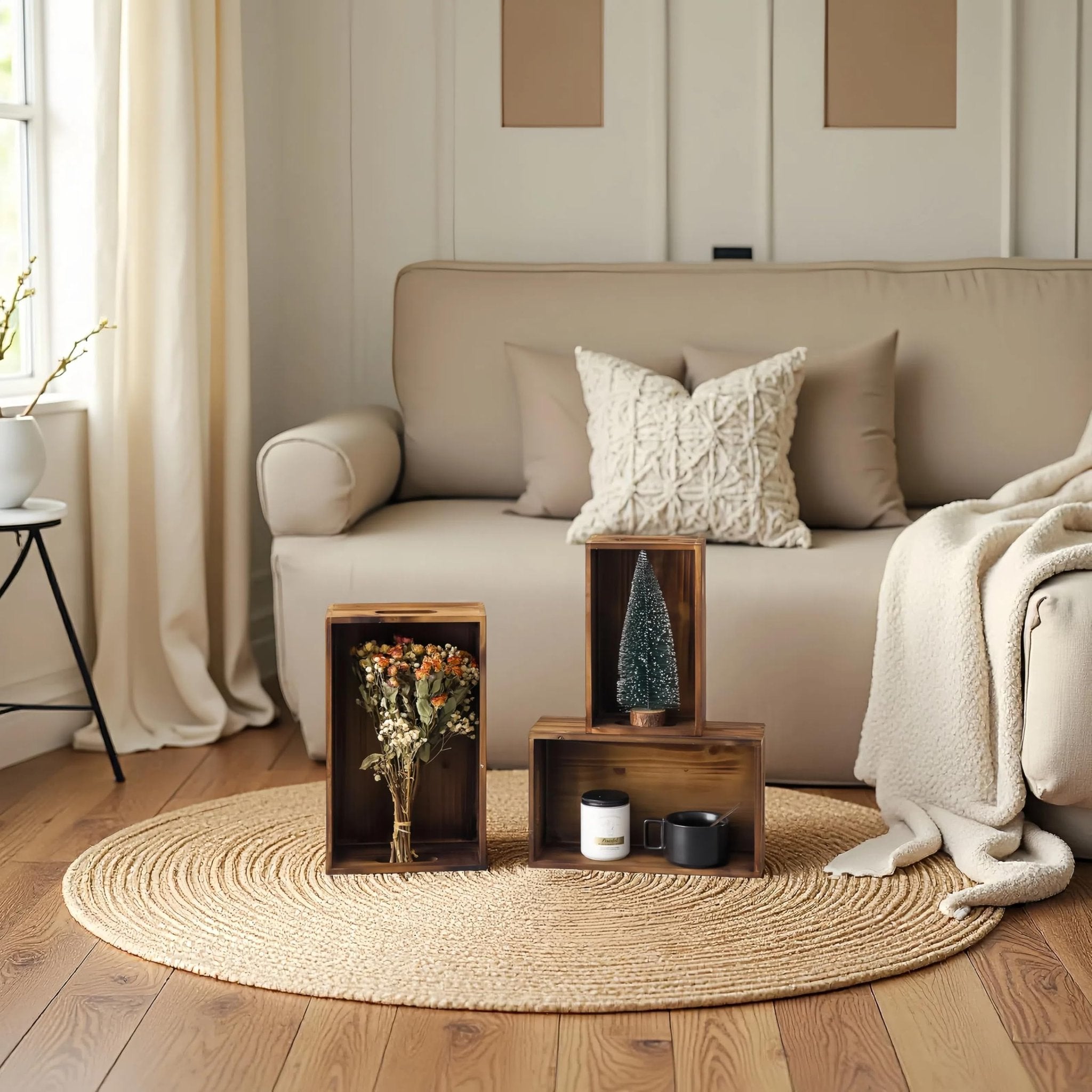 Three distressed fir wood crates with handles arranged on a round jute rug in a living room setting.