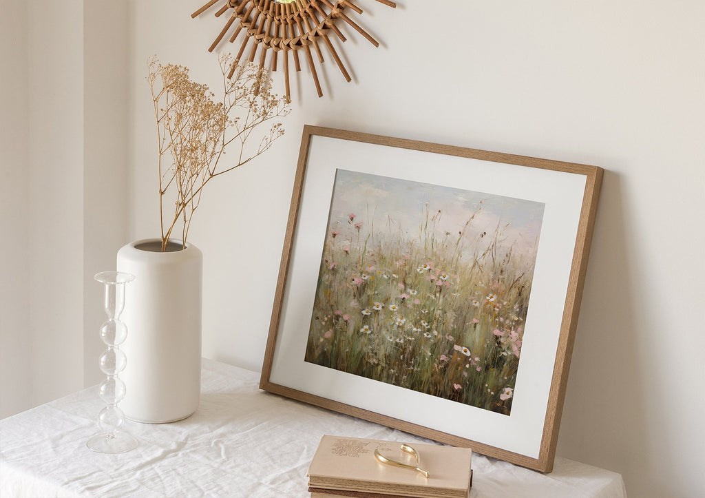 Framed wildflower art print on a table with a vase and dried flowers