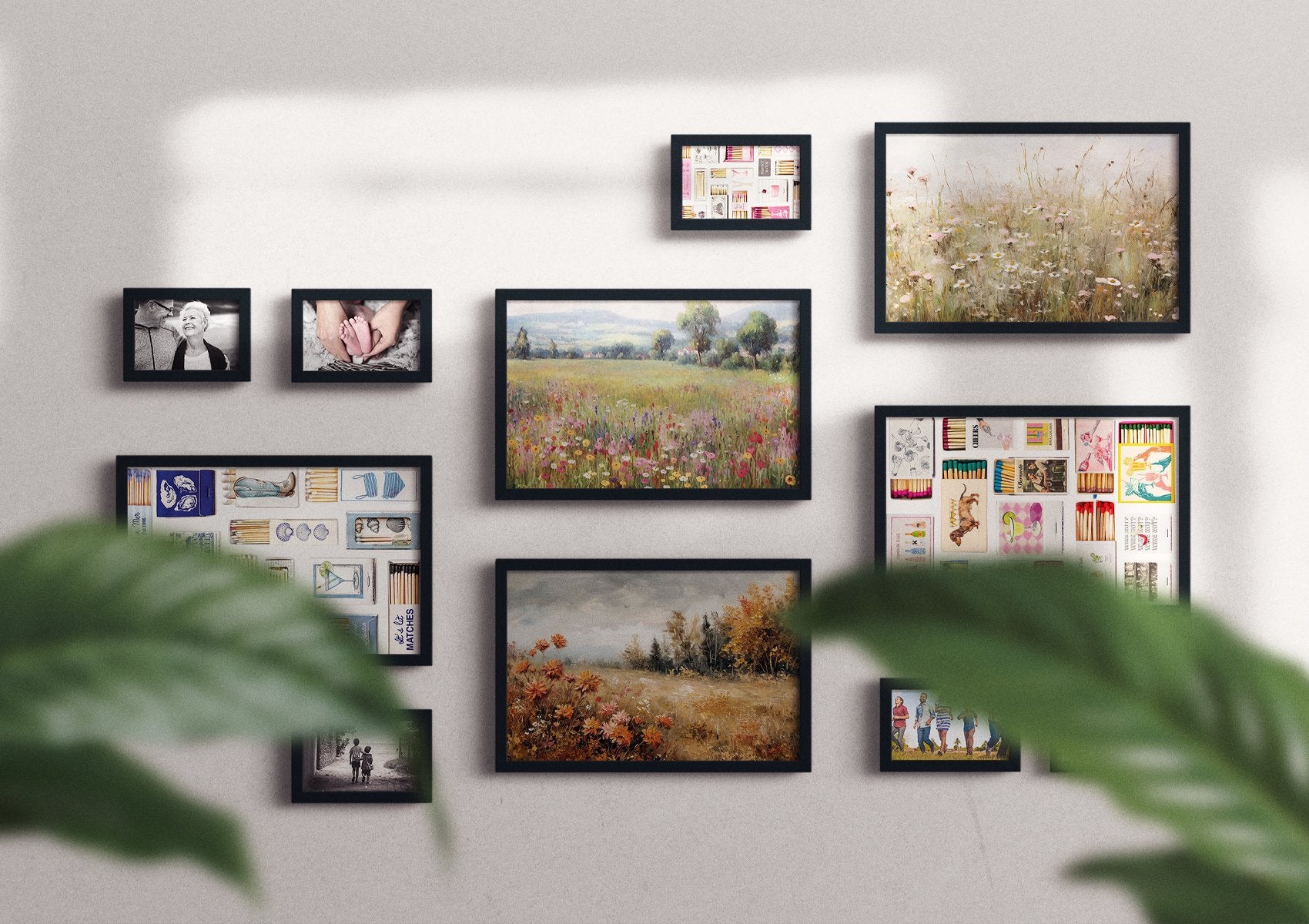 Gallery wall display of framed art prints and photographs, including landscapes and still life arrangements.