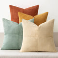 Stack of five corduroy patchwork throw pillow covers in various colors including teal, orange, yellow, and cream.