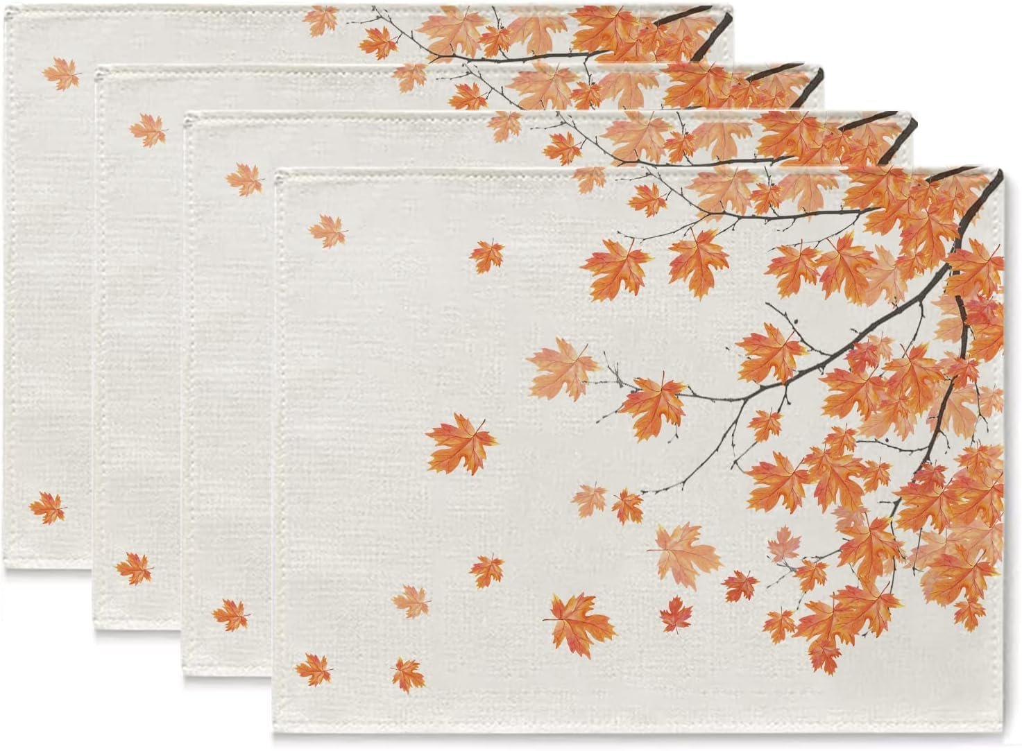 Set of four fall placemats with autumn maple leaves design, shown from an angled top-down view.