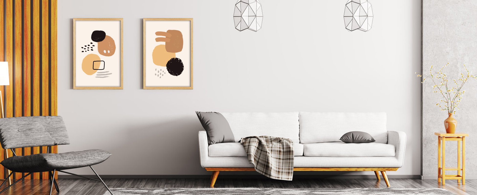 Two framed abstract art pieces hanging on a wall above a white sofa in a living room setting.