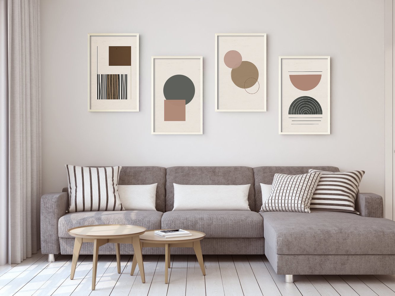 Four framed abstract art prints displayed above a sectional sofa with coffee tables in a living room setting.