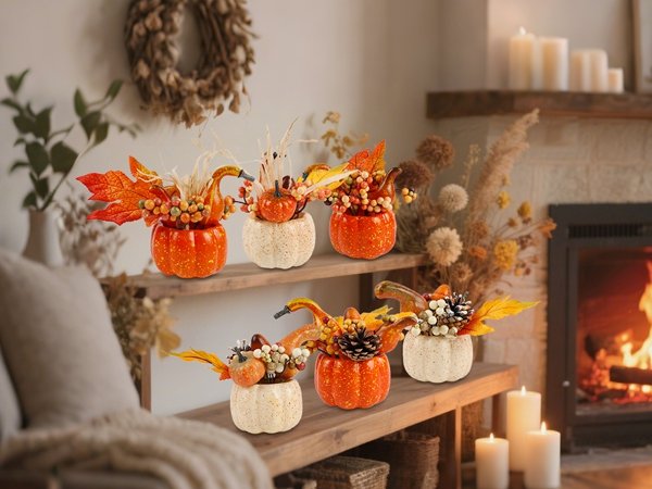 Set of six artificial pumpkins with fall foliage and berries arranged on shelves, with a fireplace in the background.