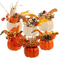 Set of six artificial fall centerpieces with pumpkins, berries, pine cones, and leaves on a white background.