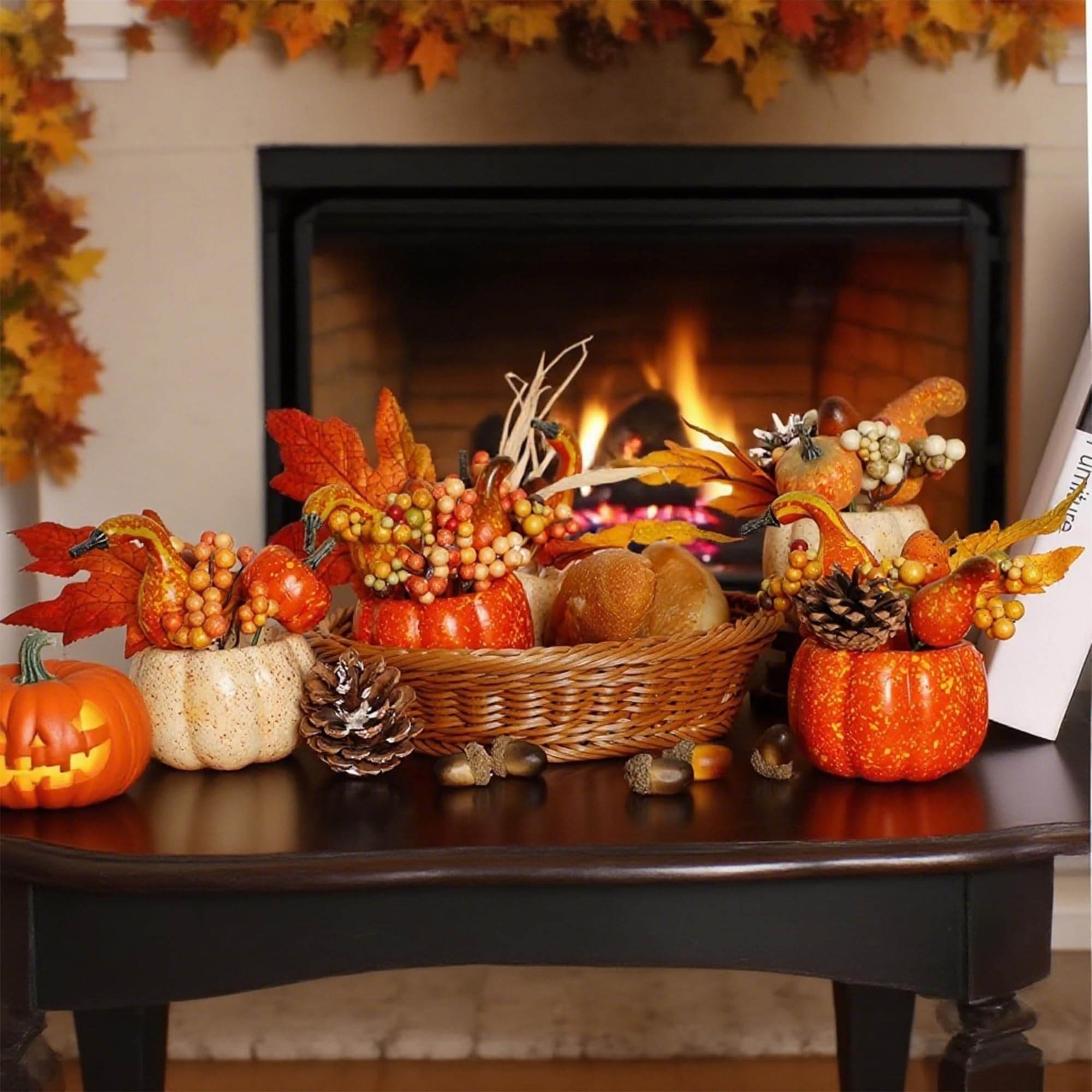 Fall centerpiece with pumpkins, berries, pine cones, and acorns arranged on a table in front of a fireplace.