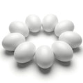 Nine white wooden eggs arranged in a circle on a white background.