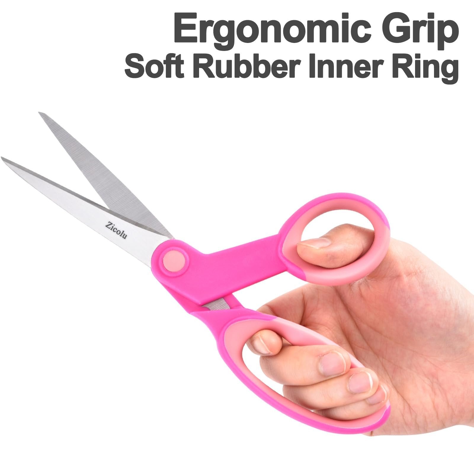 Pink ergonomic scissors held in a hand, showing the blades and soft rubber inner grip.