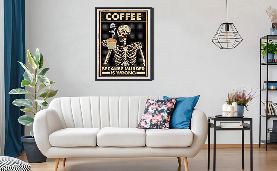 Skeleton holding a coffee cup with text "COFFEE BECAUSE MURDER IS WRONG" on a framed poster hanging on a wall above a sofa.