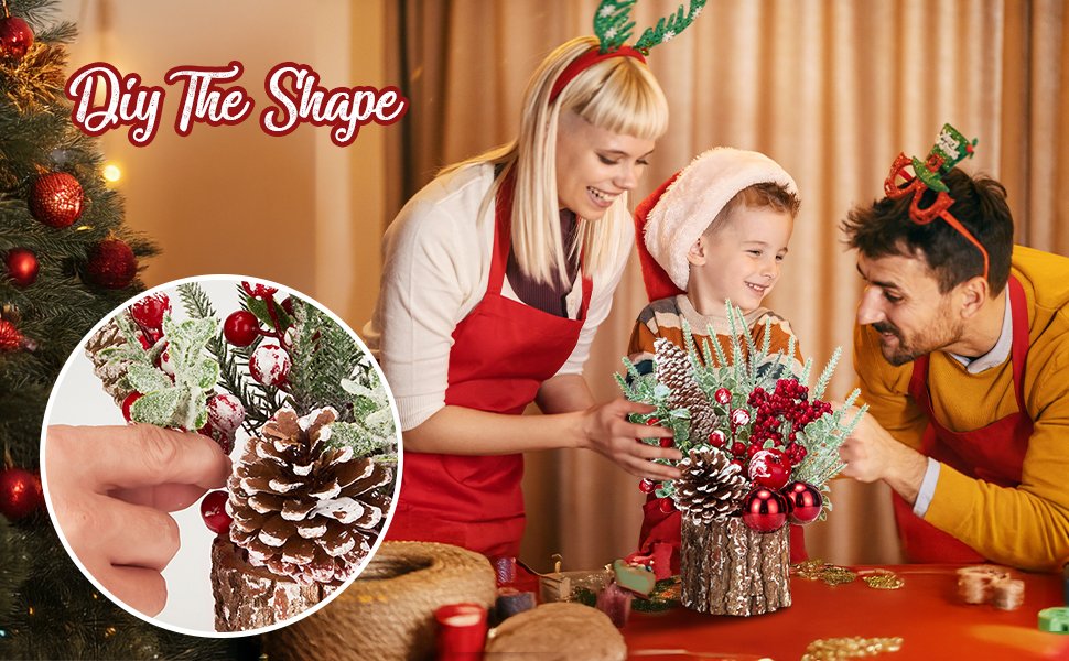 Family assembling a small artificial Christmas tree with red ornaments, berries, and pinecones in a wooden base.