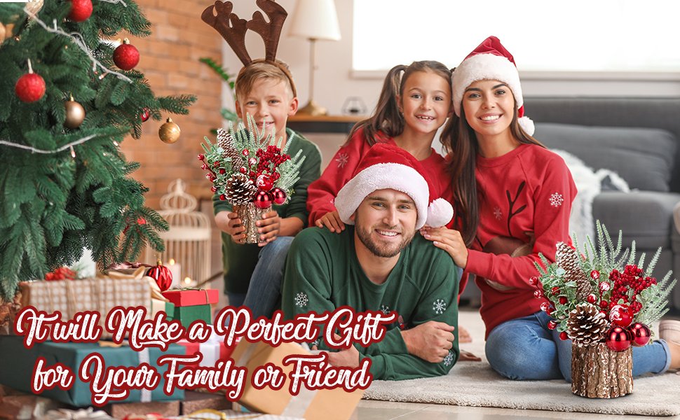 Family in Christmas sweaters and hats posing with festive decorations and gifts