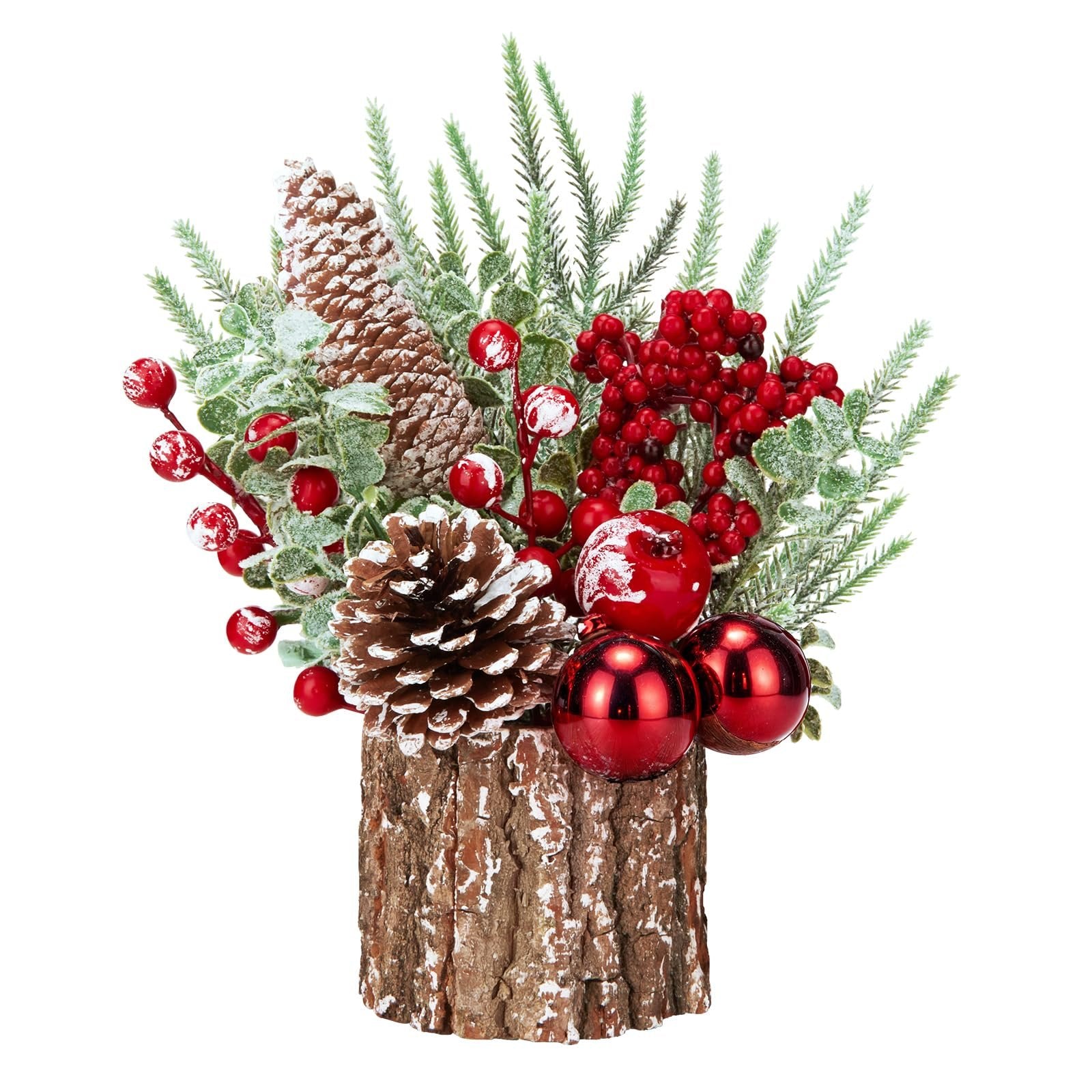 Small artificial Christmas tree arrangement with pinecones, red berries, ornaments, and a wooden base on a white background.