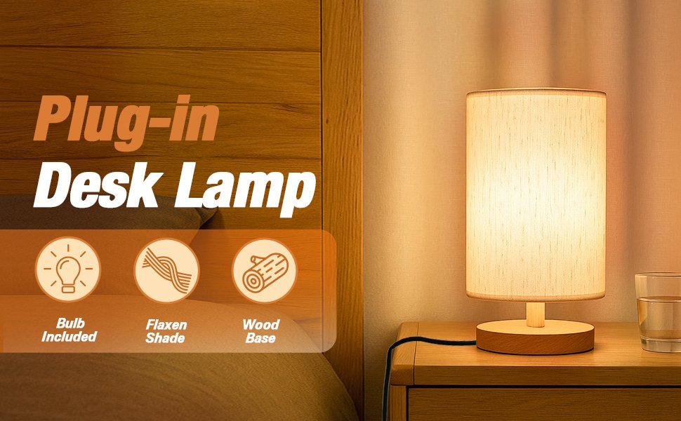 Small plug-in desk lamp with a flaxen fabric shade and wood base on a nightstand next to a bed.