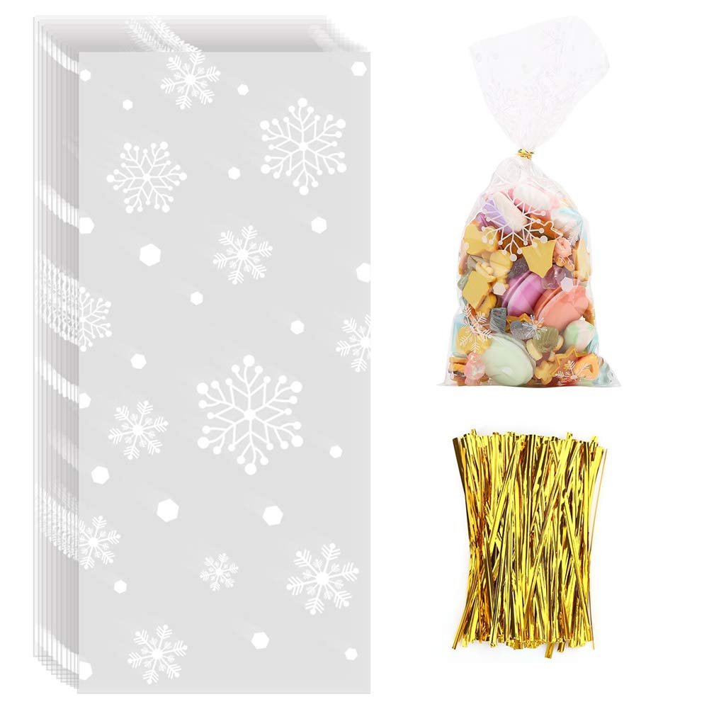 Stack of snowflake-patterned cellophane treat bags next to a filled bag and gold twist ties