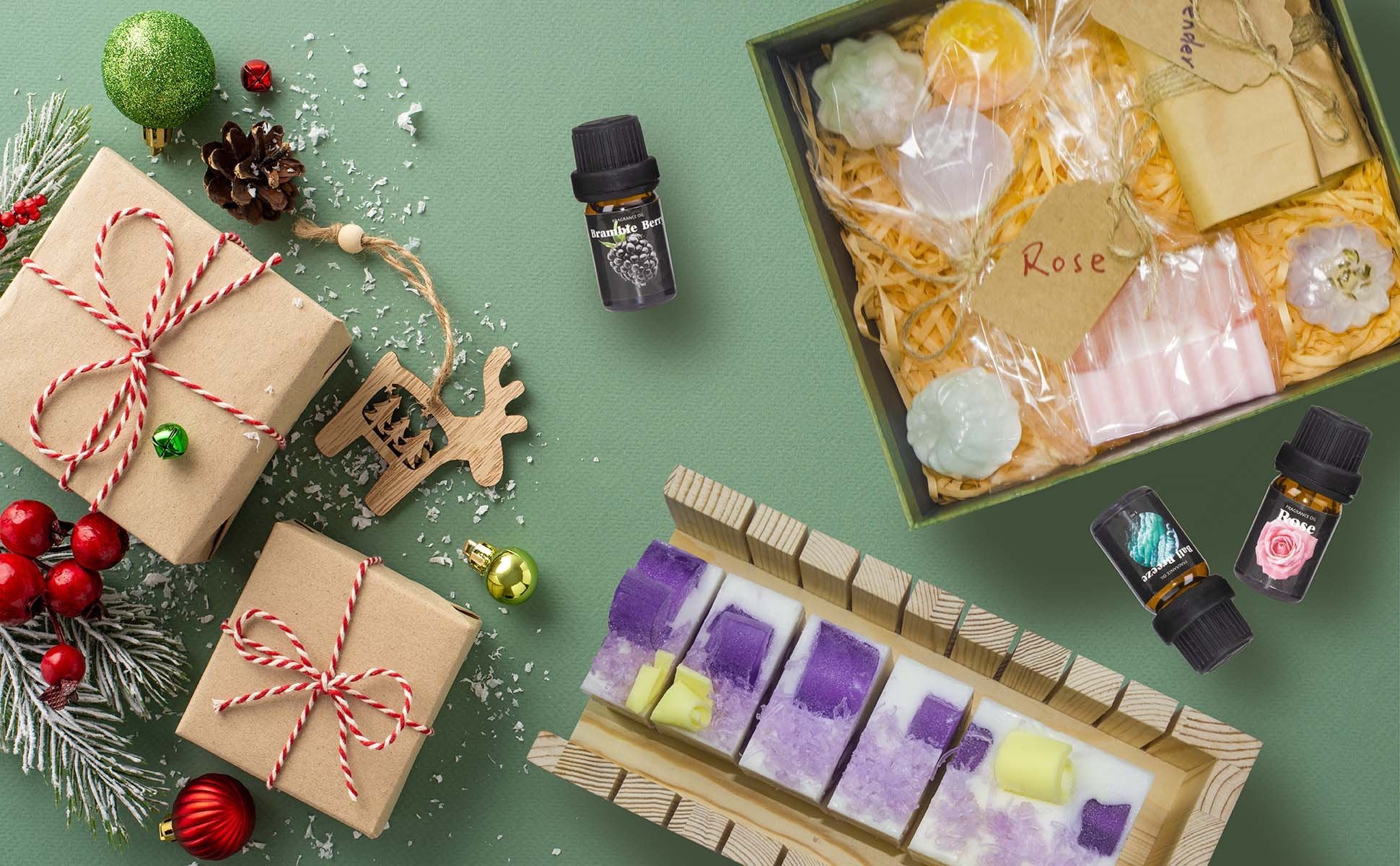 Soap making kit components arranged for a festive holiday display with gifts and ornaments.