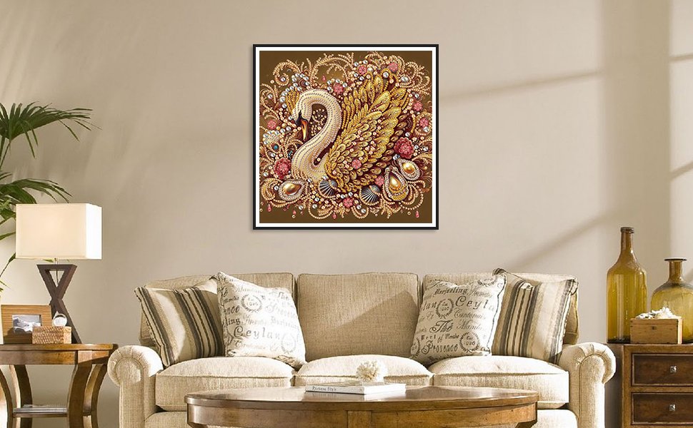 Diamond painting kit featuring a golden swan design with intricate beadwork, framed and hung above a sofa.