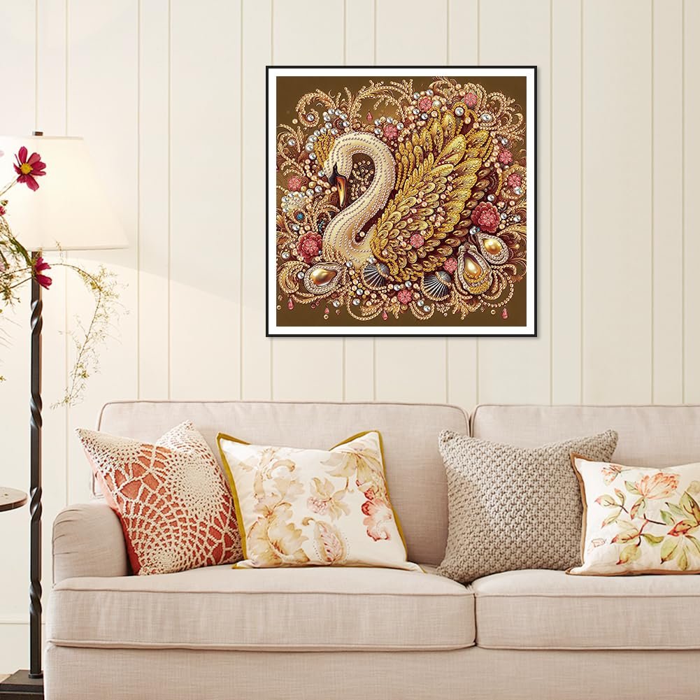Diamond painting kit featuring a golden swan surrounded by ornate floral and jewel-like embellishments, framed and hanging above a sofa.
