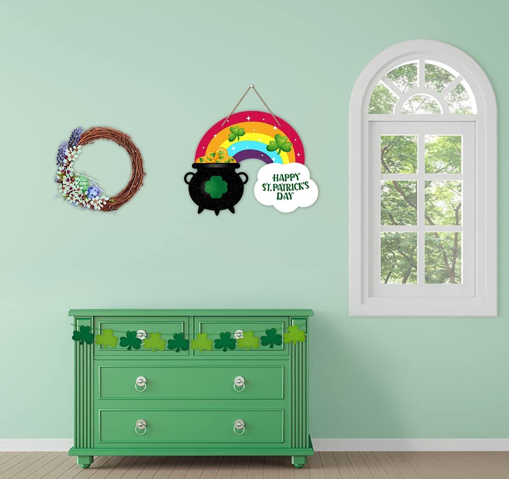 St. Patrick's Day rainbow pot of gold door sign and wreath hanging on a wall above a green dresser.