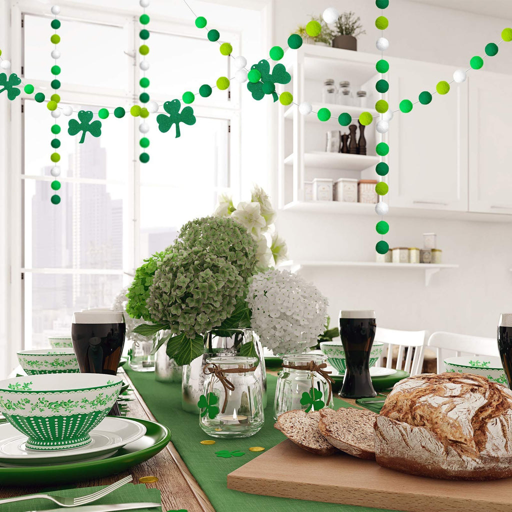 St. Patrick's Day table setting with green pom pom garlands and shamrock decorations