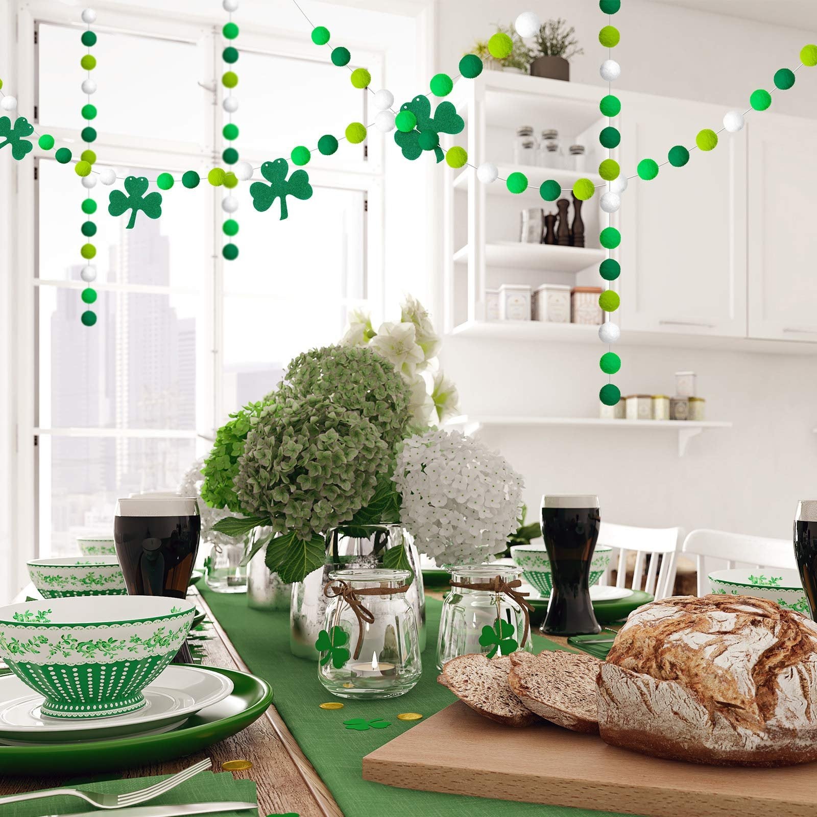 St. Patrick's Day table setting with green pom pom garlands and shamrock decorations