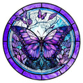 Stained glass butterfly art with purple and blue hues, featuring a large central butterfly and smaller ones on branches, set within a circular frame.