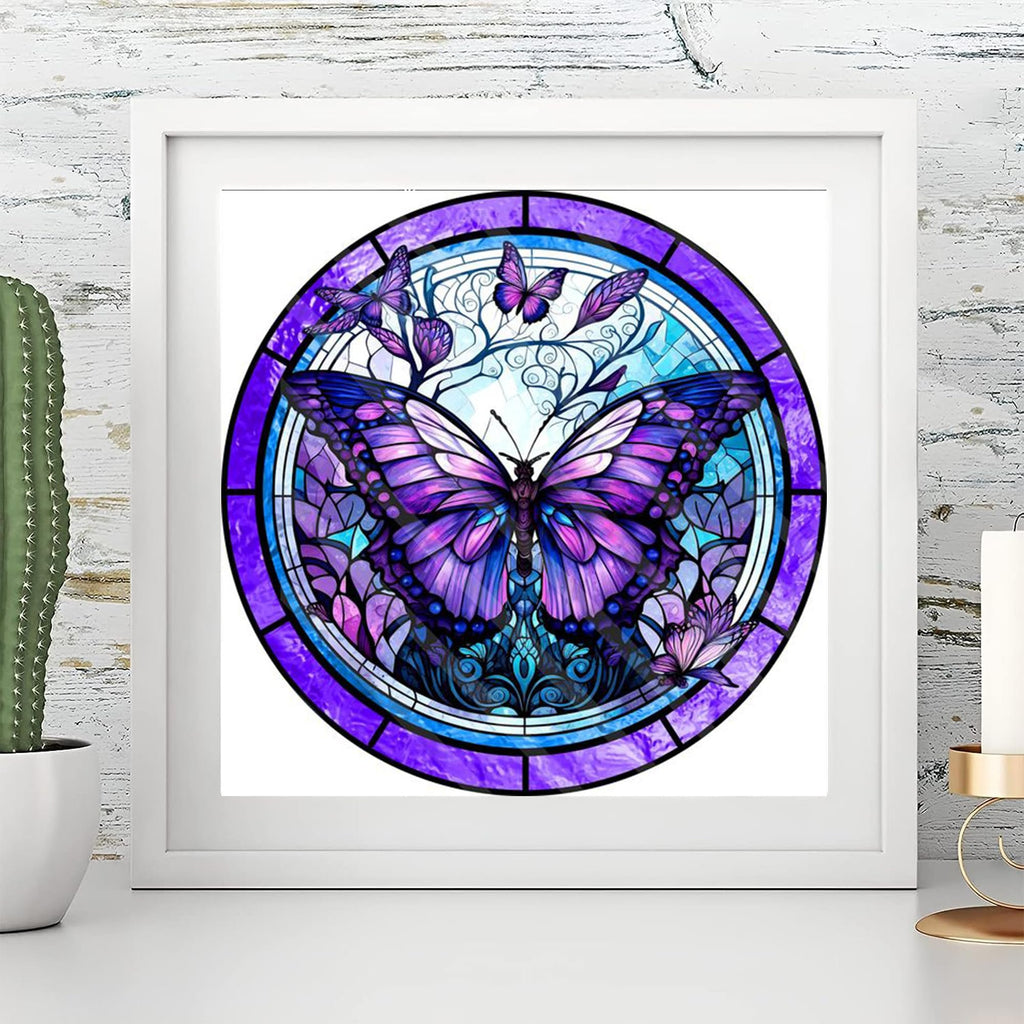 Stained glass butterfly diamond painting kit artwork framed on a white shelf with a cactus and candle holder.