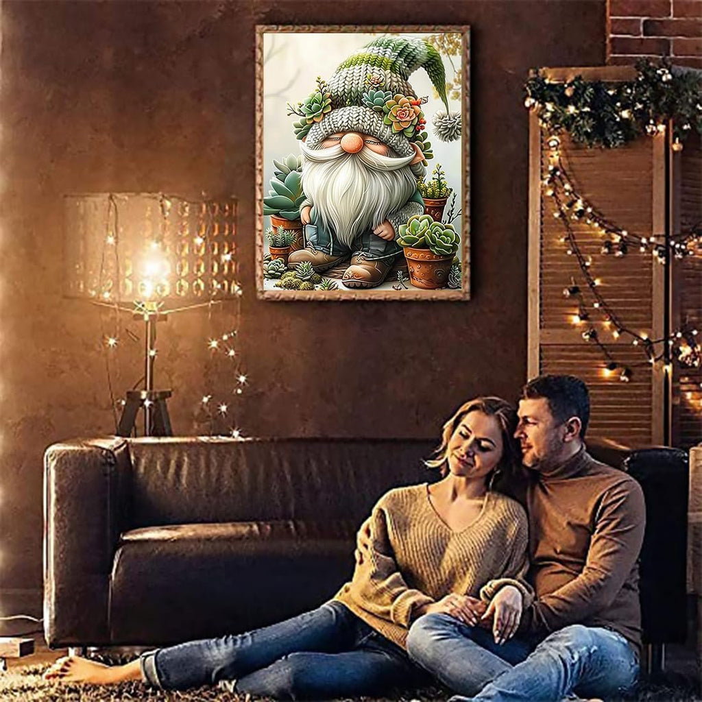 Couple relaxing on floor in front of couch with framed gnome succulent cross stitch art on wall