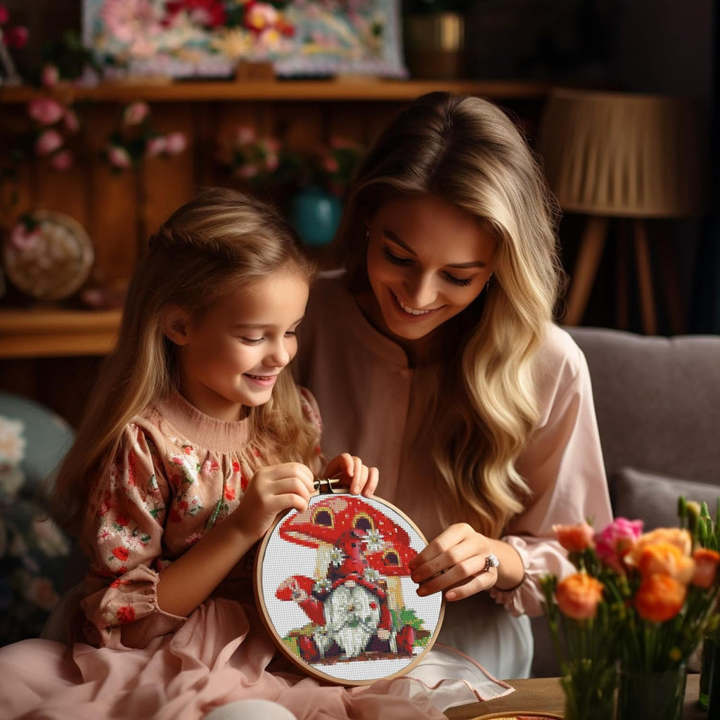 Mother and daughter smiling while doing stamped cross stitch kit with gnome mushroom design