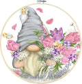 Stamped cross stitch kit featuring a gnome holding flowers and surrounded by bees and petals, within an embroidery hoop.