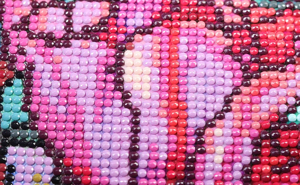 Close-up of a sun and moon diamond painting kit with pink, purple, and red rhinestones.