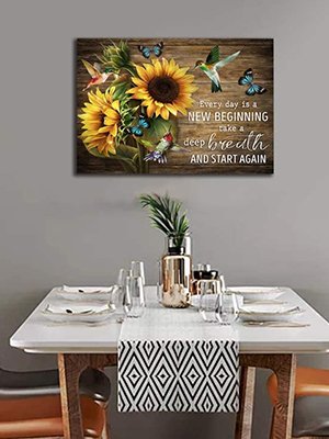 Sunflower and hummingbird wall art with inspirational quote on a wooden background, displayed above a dining table.