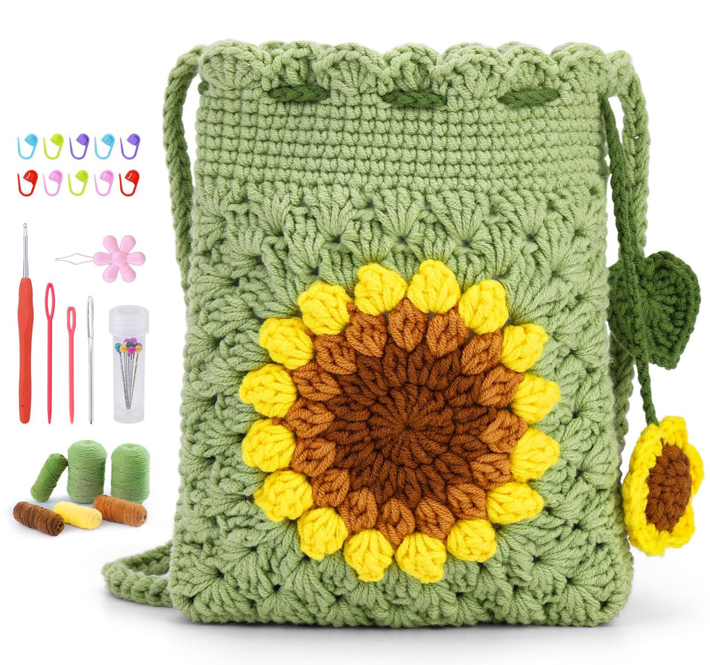 Crochet sunflower phone bag kit with yarn, hooks, needles, stitch markers, and a small flower accessory.
