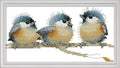 Three fluffy birds cross-stitched sitting on a branch against a white background.