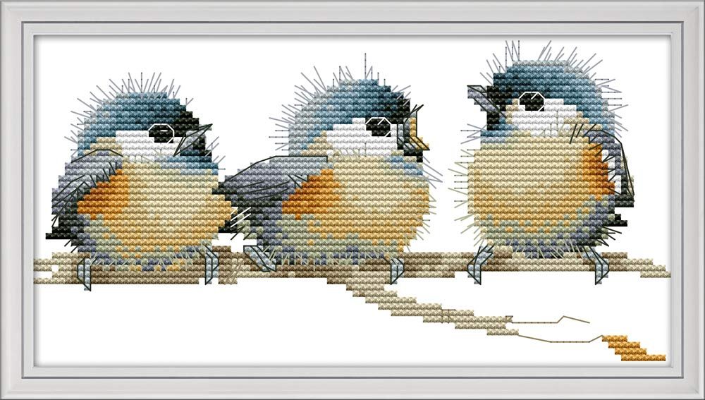 Three fluffy birds cross-stitched sitting on a branch against a white background.
