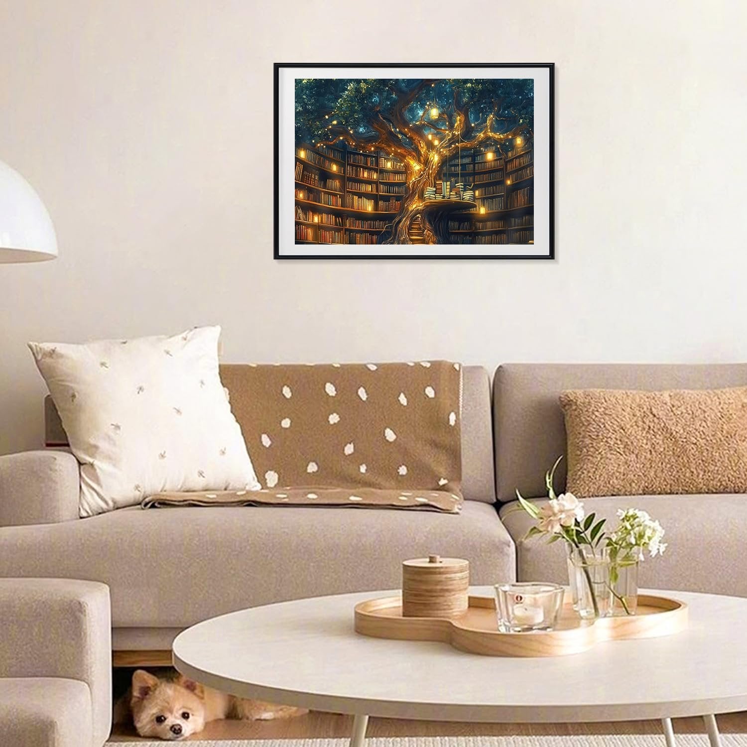Framed painting of a treehouse library with glowing lights hanging from branches, displayed on a wall above a sofa.