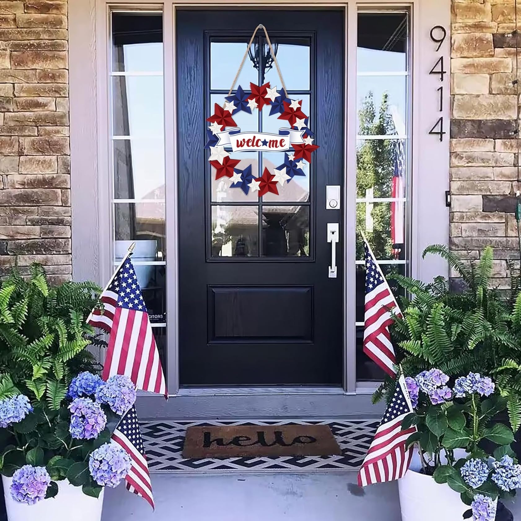 Patriotic door wreath with red, white, and blue stars and a 'welcome' banner hanging on a front door.