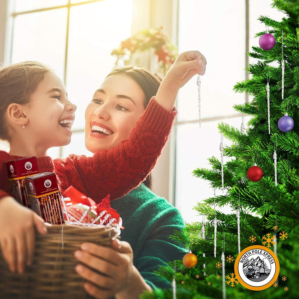 Mother and daughter decorating a Christmas tree with icicle ornaments, holding a basket of ornaments.