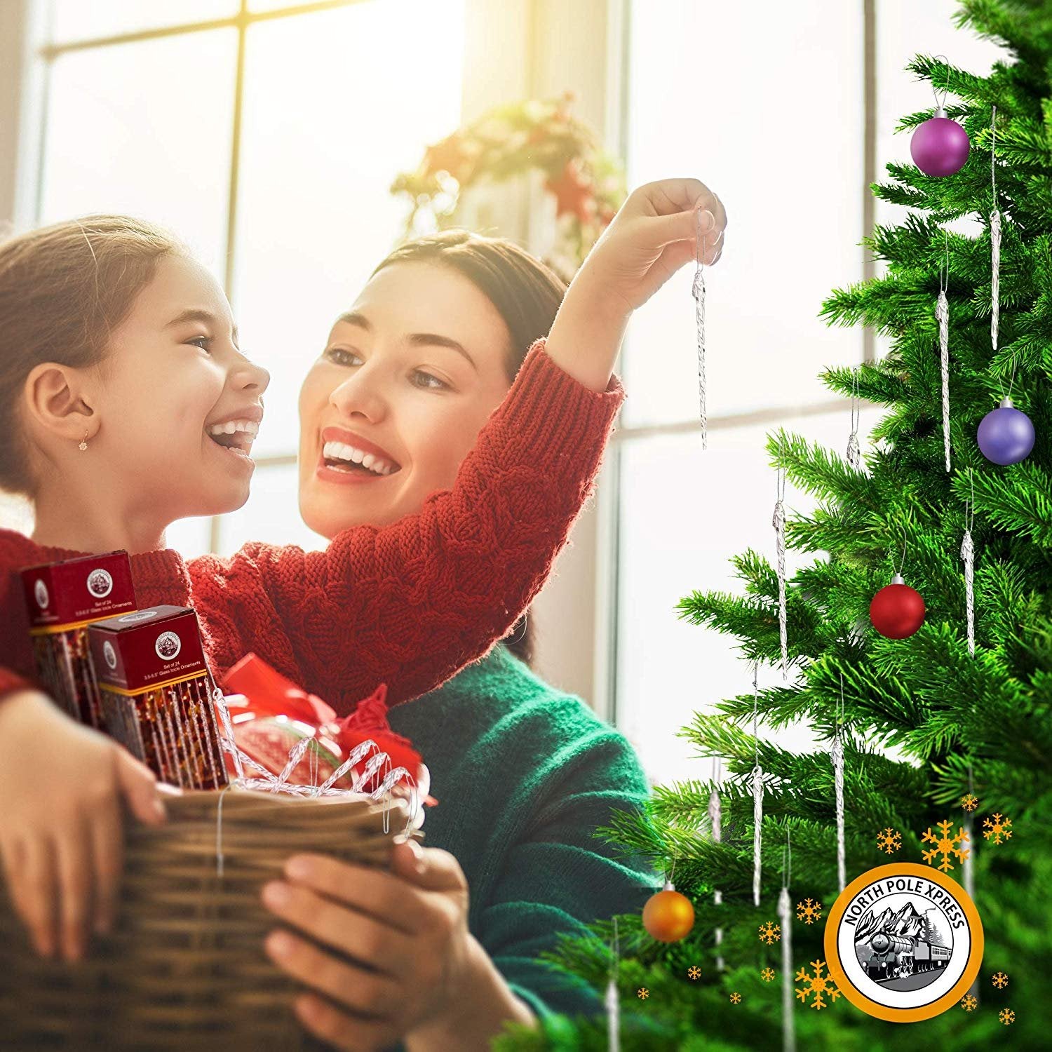 Mother and daughter decorating a Christmas tree with icicle ornaments, holding a basket of ornaments.