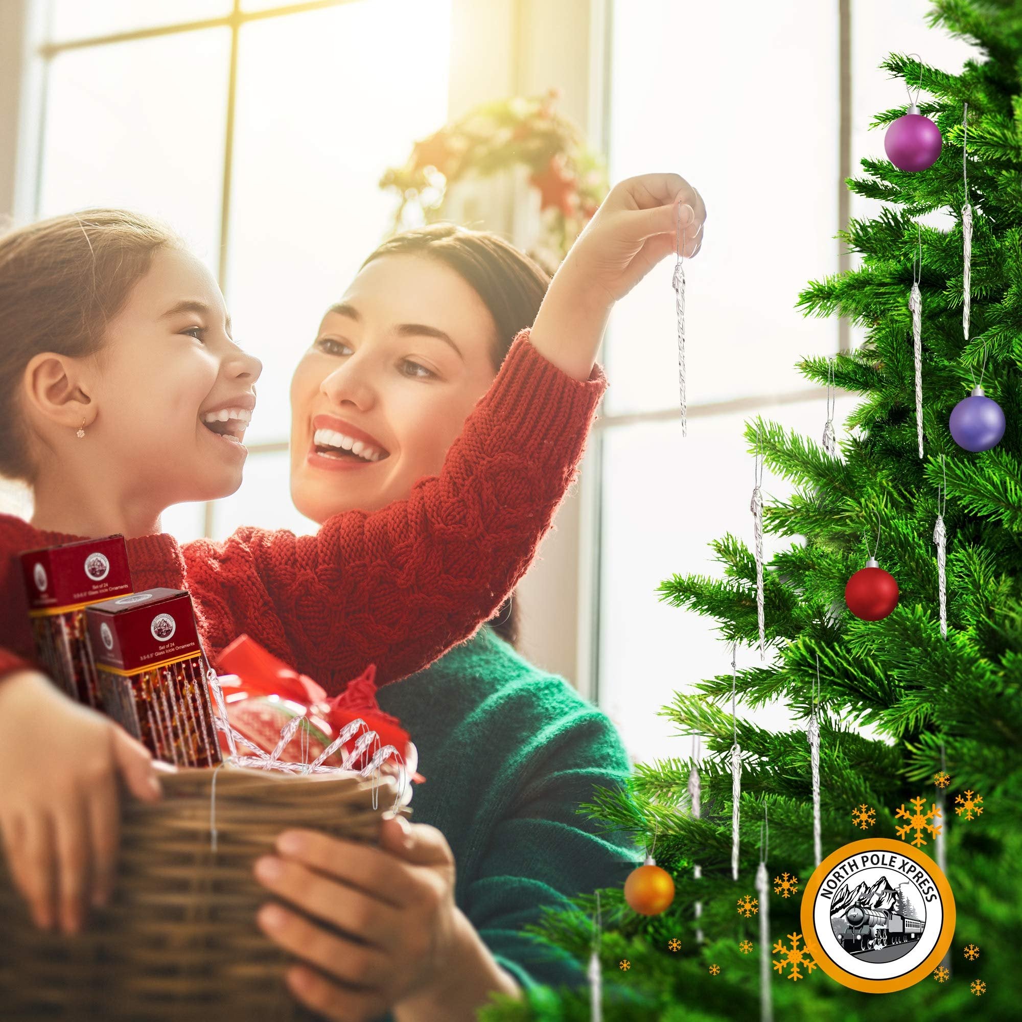 Mother and daughter decorating a Christmas tree with glass icicle ornaments from a basket.