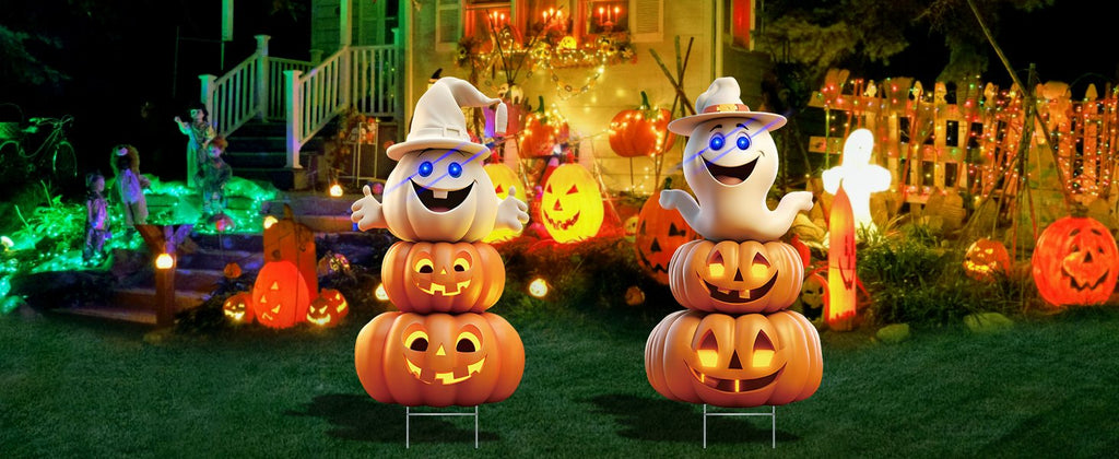 Two stacked Halloween yard signs with ghost and pumpkin figures, decorated for a spooky night display.