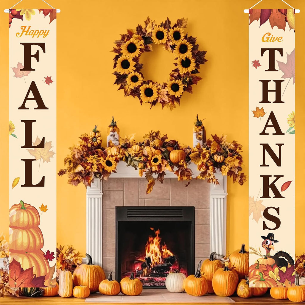 Two fall porch banners, one reading 'Happy FALL' and the other 'Give THANKS', displayed on a yellow wall above a fireplace decorated with pumpkins and sunflowers.