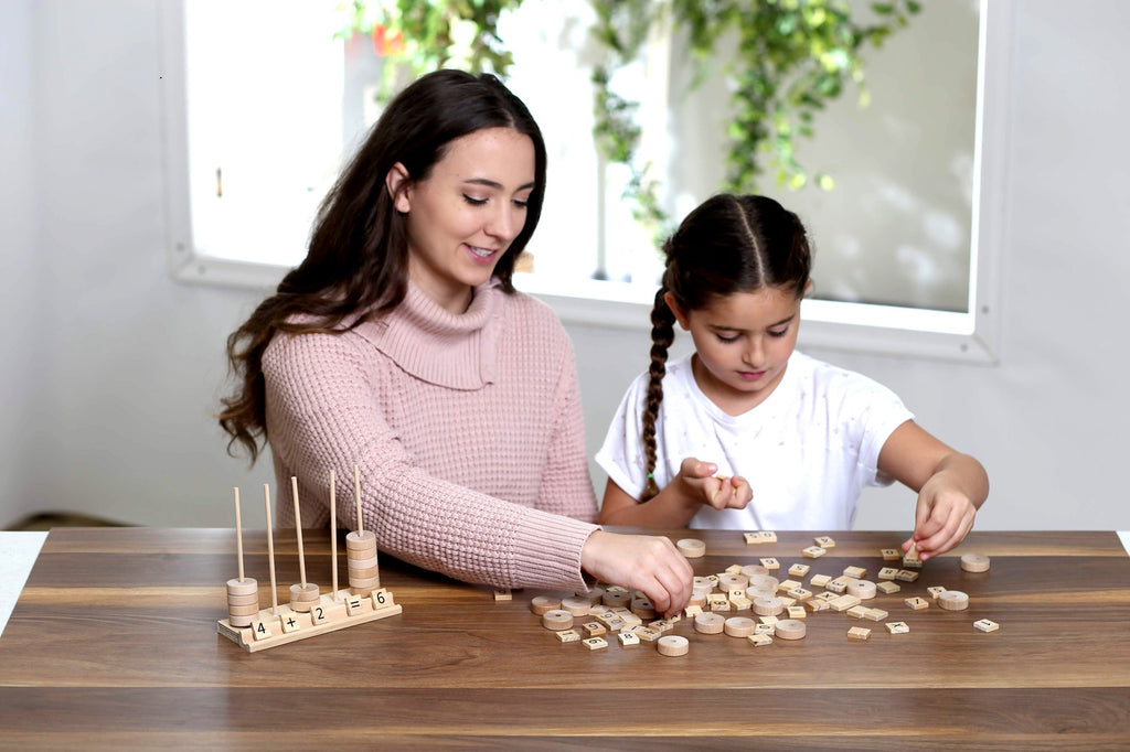 Woman and child playing with wooden math learning toys on a table
