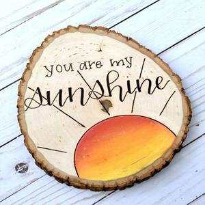Unfinished wood slice with painted sun and 'you are my sunshine' text
