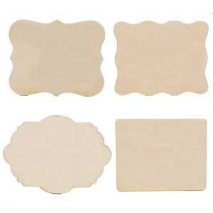 Four unfinished natural wood ornament shapes on a white background, two ornate and two rectangular.