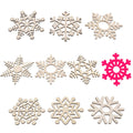 Nine assorted unfinished wooden snowflake cutouts, one bright pink snowflake cutout, on a white background.