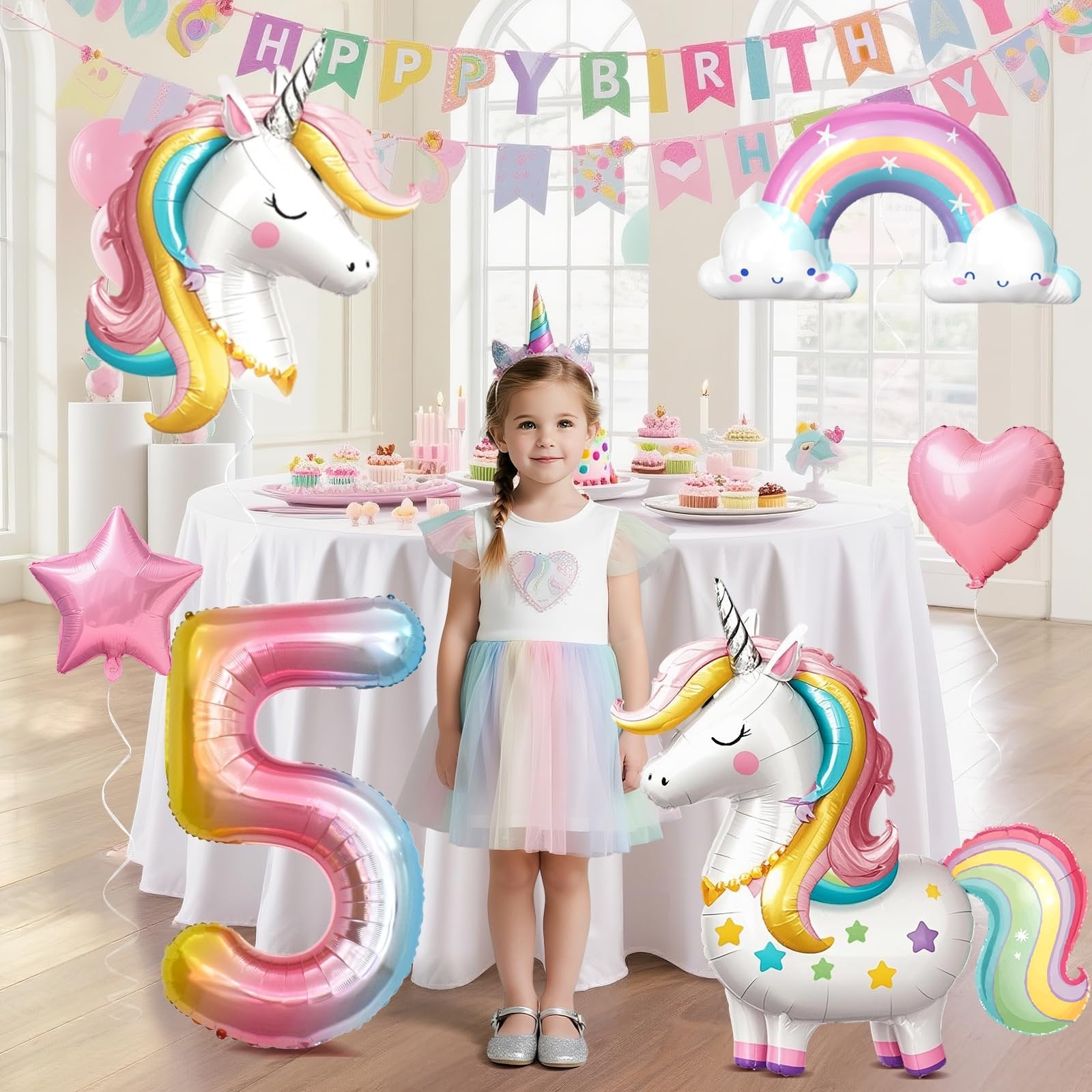 Girl in rainbow dress at unicorn-themed 5th birthday party with balloons and cupcakes