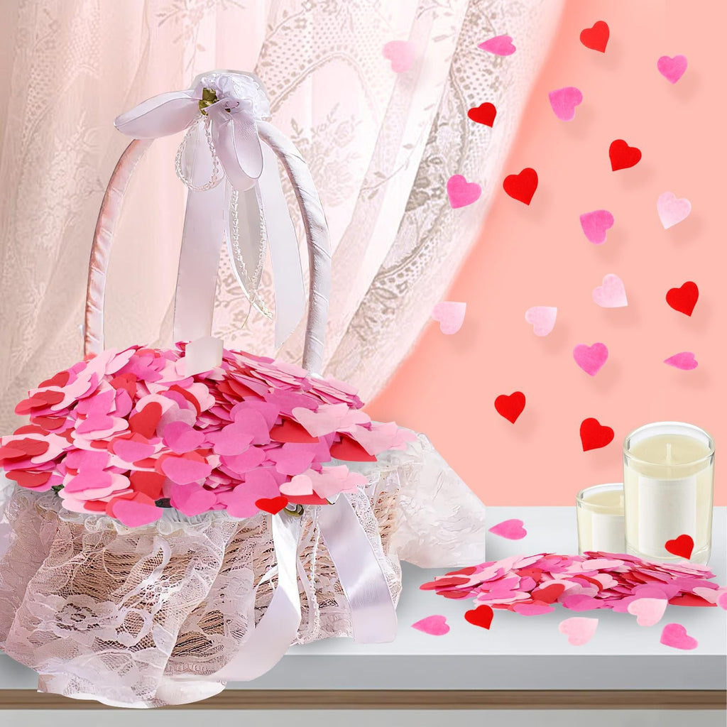 Flower girl basket overflowing with red and pink heart confetti, with scattered confetti and candles in the background.